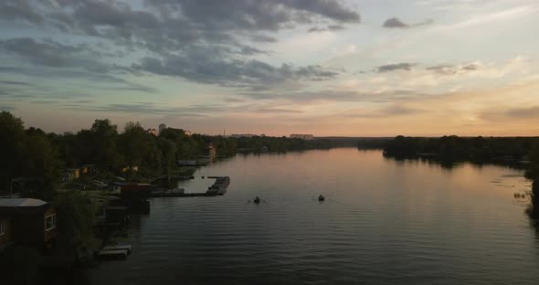 Sunset Over the River, Boat Station, Seagulls Against the Sky and People in the Boat