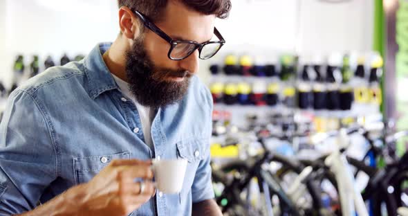 Mechanic using mobile phone in workshop alt