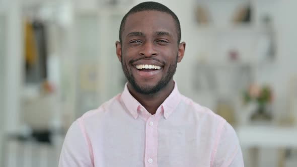 Portrait of Young African Man Smiling at the Camera alt