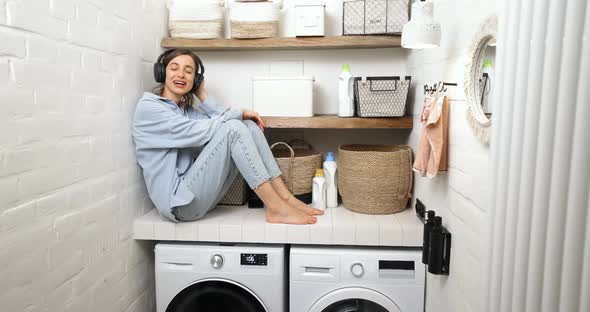 Woman Enjoys While Washing Clothes at Home alt
