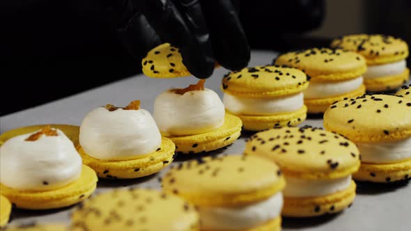 Chef is Assembling Yellow Macarons Closeup