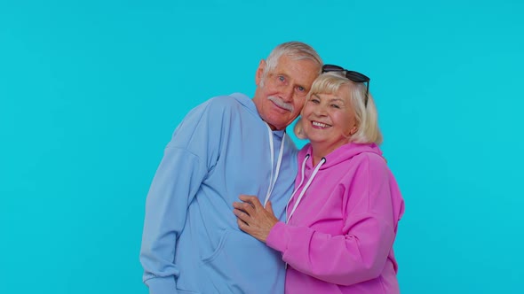 Romantic Senior Couple Grandfather Grandmother Hugging Embracing Looking at Camera and Smiling alt