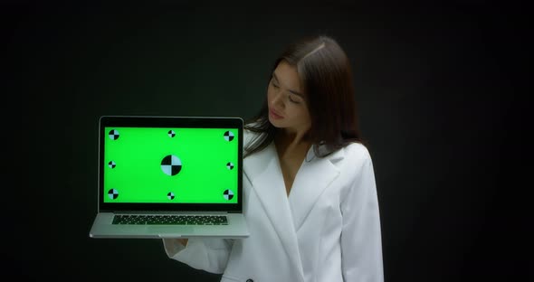 Woman Holding Laptop with Chroma Key Mockup Blank Screen