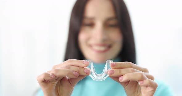 Woman Inserting Night Guard Into Her Mouth to Correct Bite  Movie Slow Motion alt