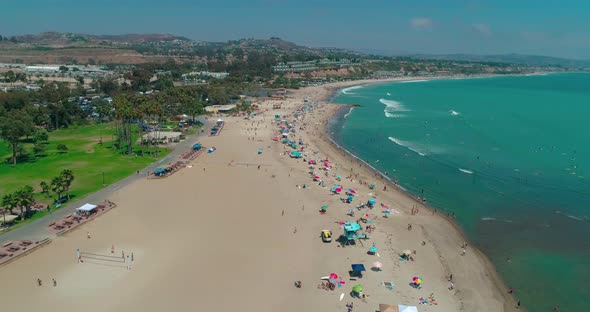 DANA POINT, California. Doheny State Beach. A Sunny Day Beach Scene with People Engaged in Beach alt