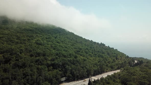 A Winding Road Through the Crimean Mountains Along the Sea alt