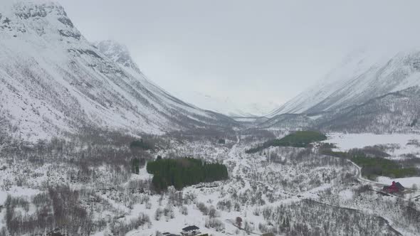 Snowy Landscape At Kåfjord Town In Olderdalen, Norway During Winter - aerial pullback alt