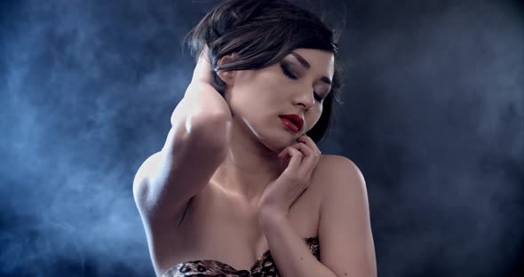 Fashion Isolated Portrait of Sexy Woman with Bright Make Up Posing and Dancing in Smoke alt