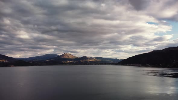 Aerial View of Calm Lake Egirdir Against Mountain Ridge and Cloudy Sky Over Them alt