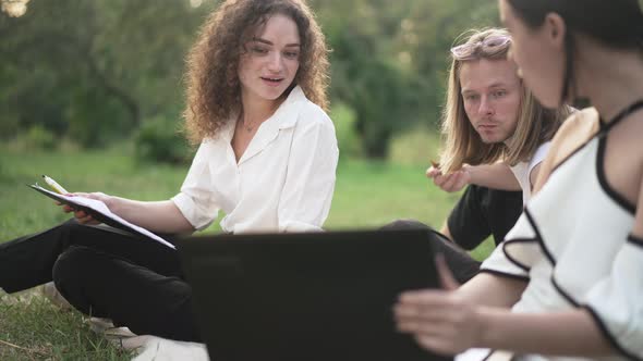 Surprised Man and Woman Listening to Colleague Showing Ebusiness Profitability on Laptop Talking in alt