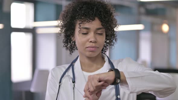 Portrait of Focused Professional Doctor Using Smart Watch alt