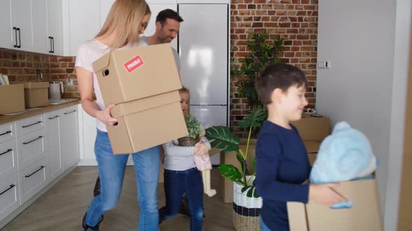 Tracking video of smiling family moving to a new home. Shot with RED helium camera in 8K. alt