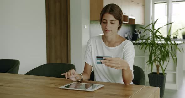 Young Woman Shopping at Home With Credit Card