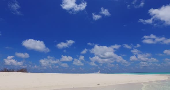 Beautiful fly over tourism shot of a paradise sunny white sand beach and blue sea background in hi r alt