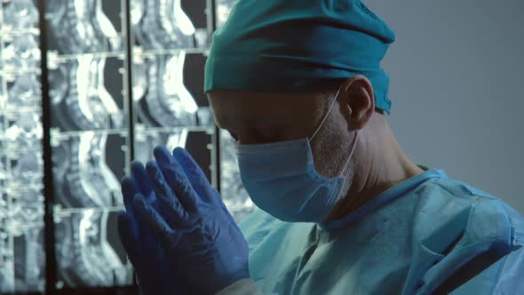 Doctor Clasping Hands for Prayer, Hope for Miracle Before Difficult Surgery alt