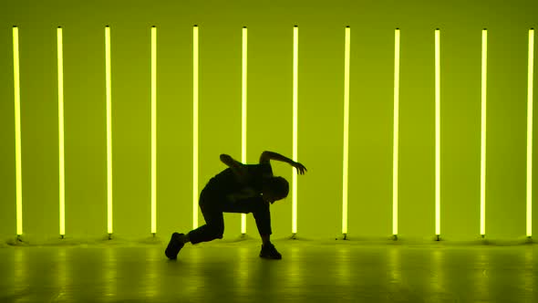 Young Woman Dancing in a Studio Illuminated By Multicolored Neon Tubesin Slow Motion alt