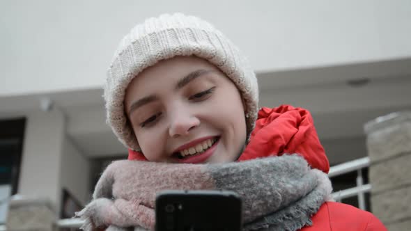 Close Up Face of Student Girl Texting with Friends in Online Chat on Smartphone alt