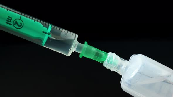 Plastic medical syringe with needle and plastic vial. Medical injection concept.