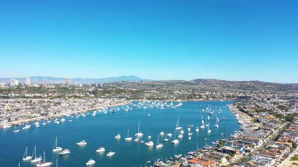 An aerial view of stunning Newport harbor on a sunny day full of luxury boats alt