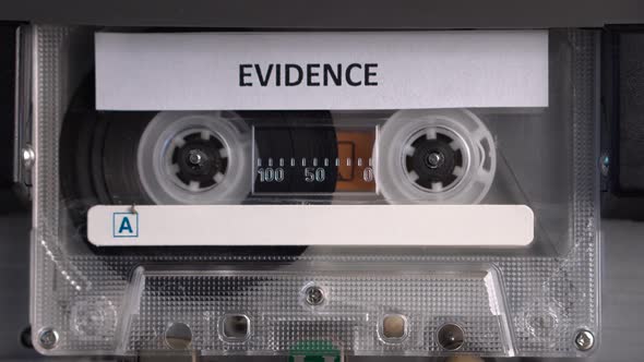 Audio Cassette Tape With Evidence Recording Rolling in Deck Player Close Up alt