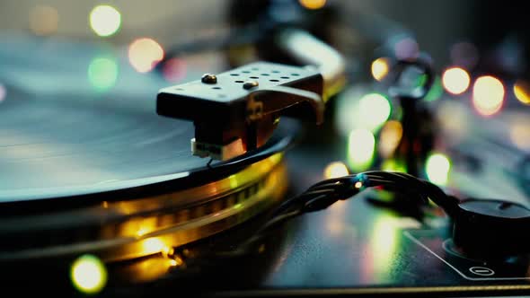 Festive Mood, Bokeh Lights Shining Over Vintage Vinyl Turntable Record Player Needle Close Up Djing