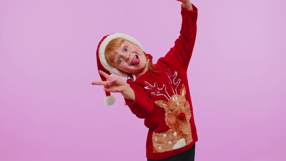 Girl in Christmas Sweater Waves Hand Palm in Hello Gesture Welcomes Someone to Celebrate New Year alt