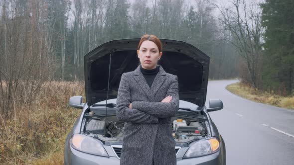 Slim Woman at the Background of Broken Car in the Forest