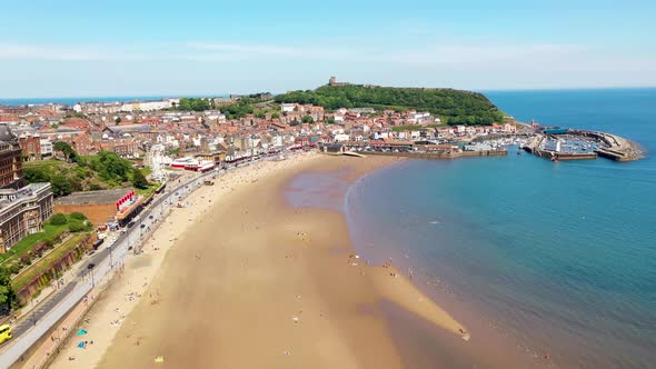 Aerial drone footage of the beach front in the town of Scarborough in North Yorkshire, England UK alt