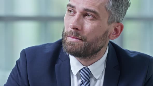 Handsome Manager Writing in Notebook alt