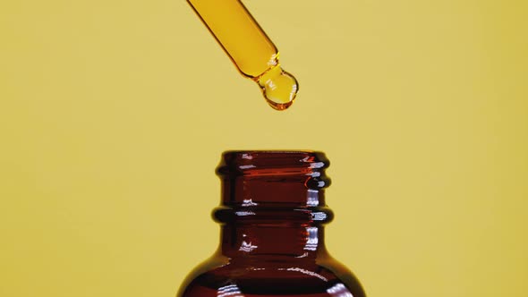 Organic Seed Oil Dripping From Pipette Into Jar alt