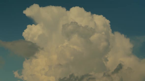 Thick White Clouds Float Across the Blue Summer Sky