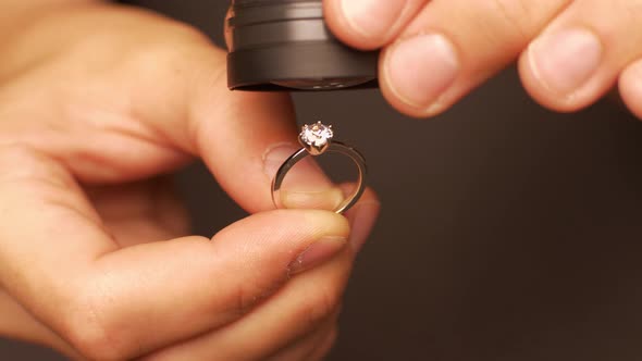 Man Examines Diamond in Ring