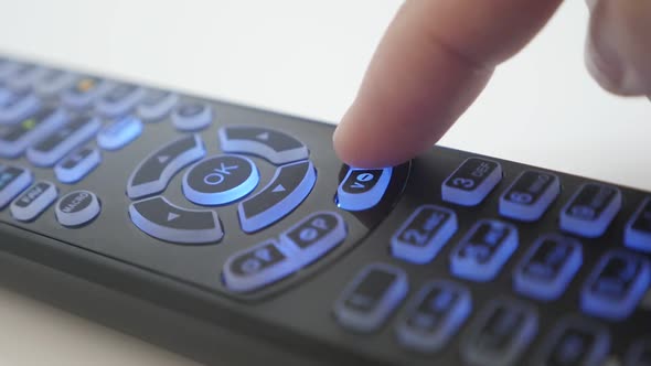 Volume level  button pressing on  TV remote control slow motion  footage