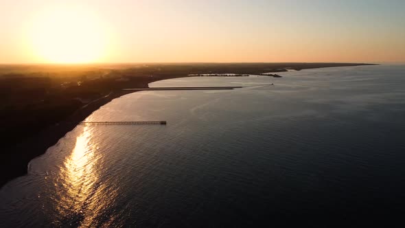 Aerial cinematic drone footage of the sea at sunset alt