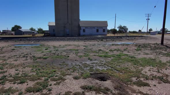Slow dolly forward toward old grain silo and shop in Nunn Colorado. alt