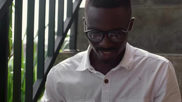 Male Freelancer Sitting on Stairs alt