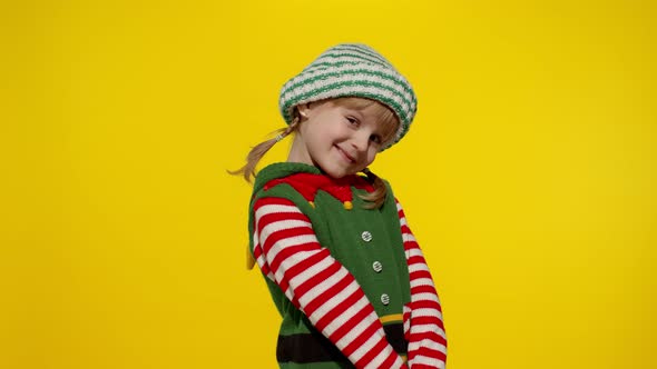 Shy Shamed Child Girl Christmas Elf Santa Helper Costume Posing Looking Camera Feels Guilty alt