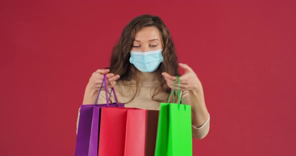 Studio Portrai of Caucasian Happy Woman Shopaholic Teen Girl Shopper Consumer Wears Medical Mask on alt