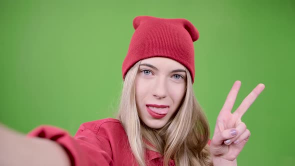 Teenager Makes Selfie with Different Emotions. Green Screen. Close Up. Slow Motion alt