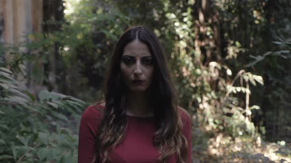 Serious confident walking towards the camera in the forest-slow motion alt