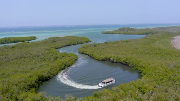 Tourist boat cruises in coastal mangroves of Monte Cristi National Park alt