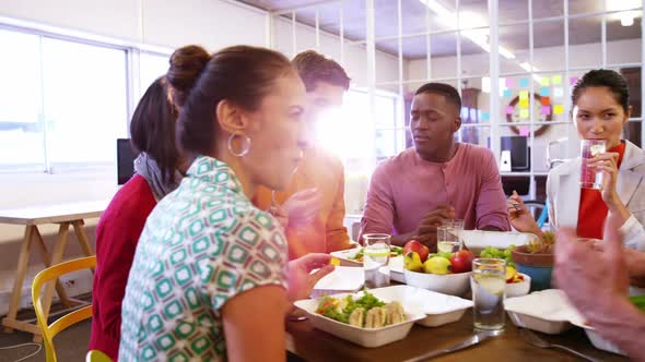 Group of business executives having breakfast alt