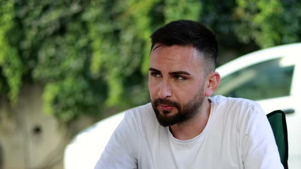 Bored and seedy thoughtful bearded young man. Man thinking about a problem