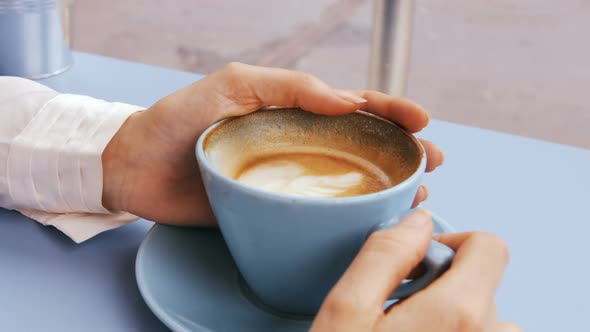 Businesswoman having cup of coffee alt
