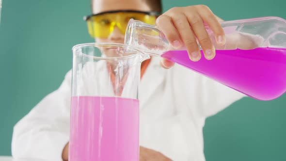 Schoolboy doing a chemical experiment in laboratory 4k alt