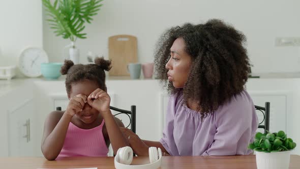 Compassious Multiethnic Young Woman Loving Mother Comforts Her Crying Daughter Sitting Together at a alt