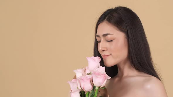 Beautiful woman smell flower alt