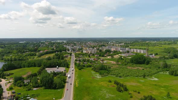 Drone Aerial View of Zarasai City, Lithuania, Road Traffic Residential Buildings and Green Landscape alt