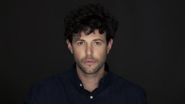 Man holding finger to lips in silence alt