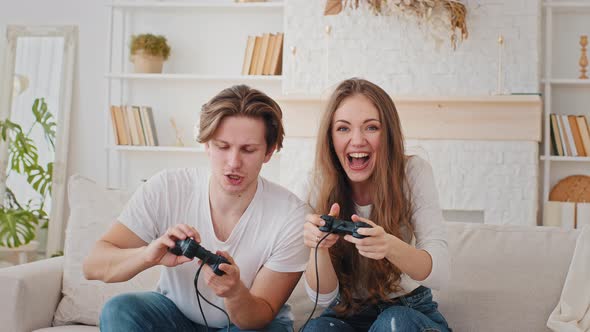 Cheerful Couple Millennials Caucasian Married Man and Woman Playing Videogame Together at Home alt